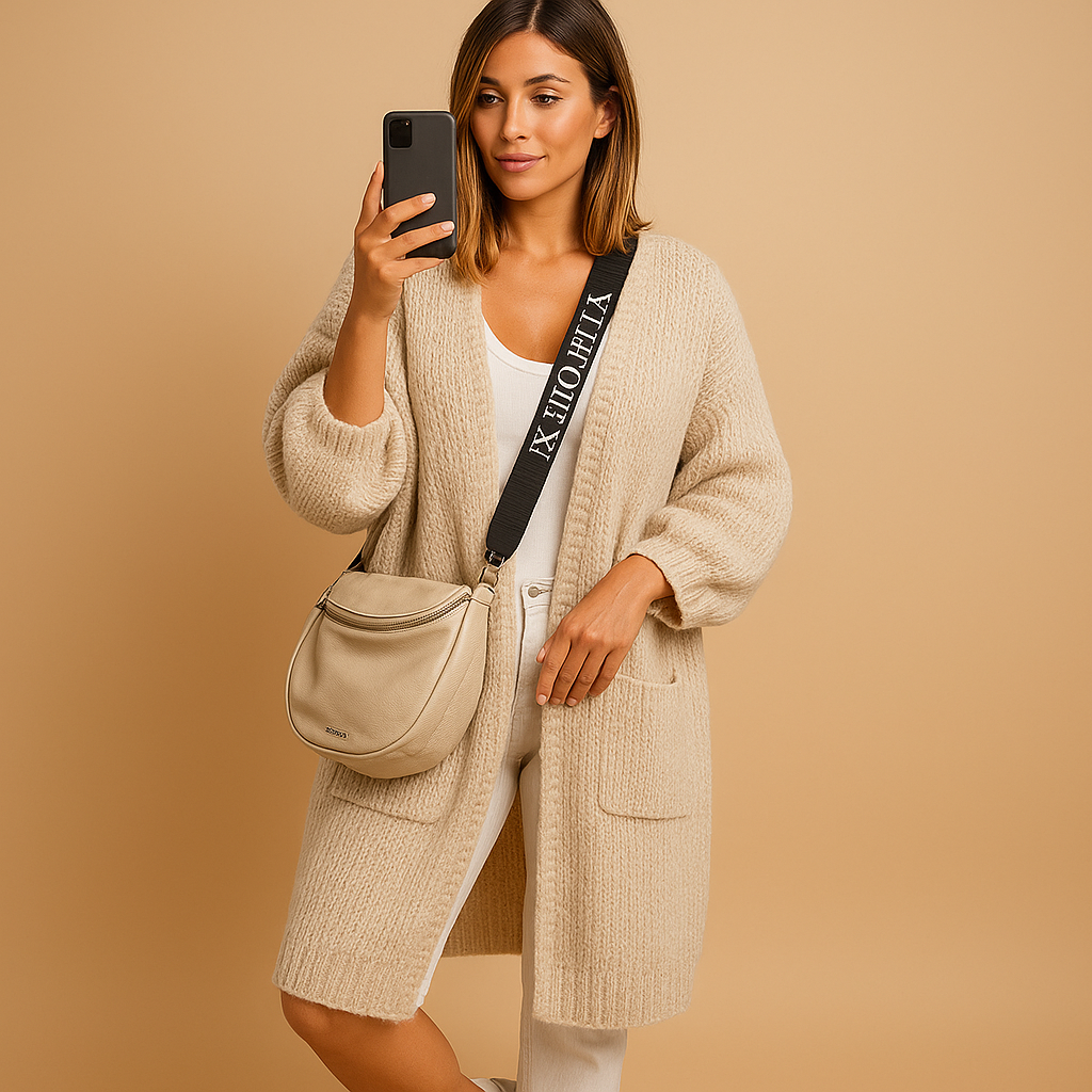 Women’s oversized open cardigan with flowing fit, open front, and refined tailored details. Lightweight and stylish for chic layered outfits.