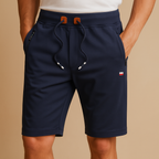 Men’s breathable sport shorts with elastic waistband and multiple pockets, available in black, green, gray, beige, and blue for versatile use.