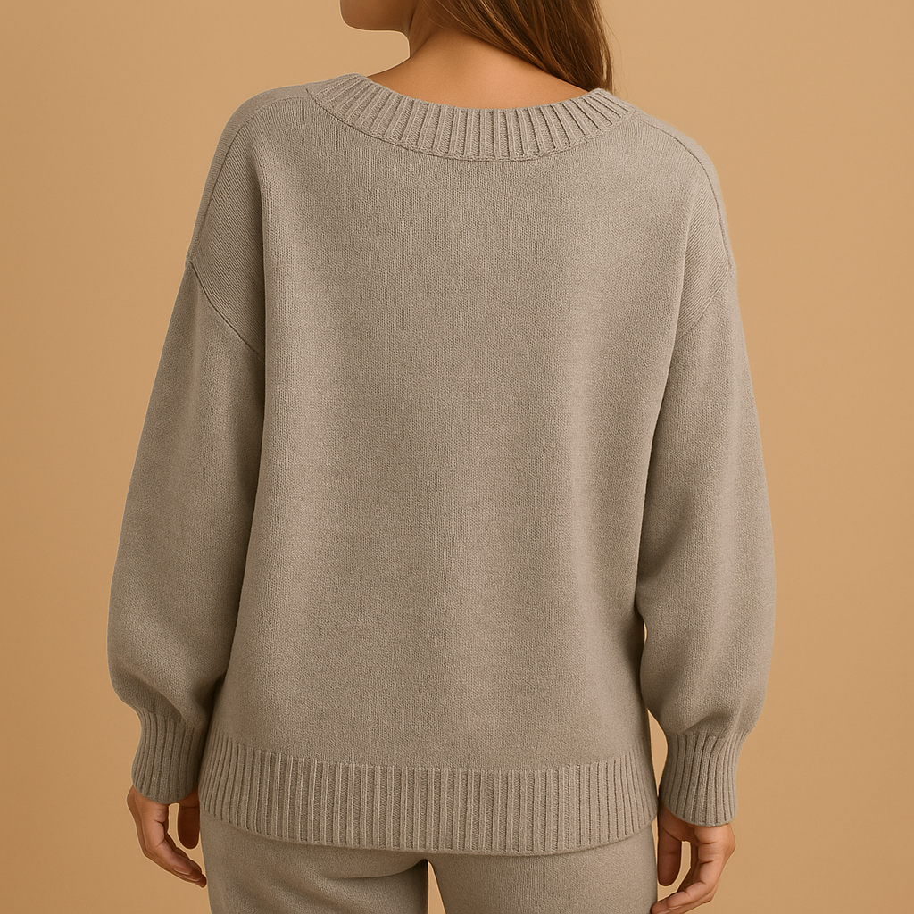 Women’s knitted sweater with elegant V-neck in neutral winter tones, featuring a slim fit and breathable fabric for casual or office looks.